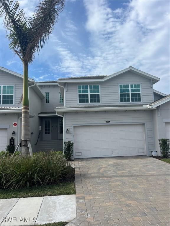 view of front of house featuring an attached garage and decorative driveway