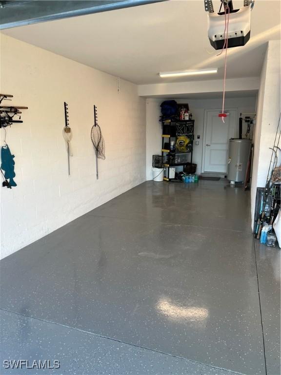 garage with water heater and a garage door opener