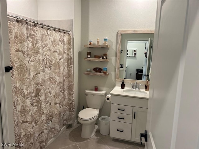 bathroom with toilet, tile patterned floors, and vanity