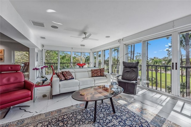 sunroom / solarium featuring ceiling fan