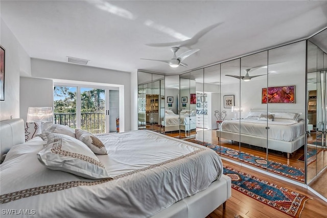 bedroom featuring hardwood / wood-style floors, ceiling fan, and access to outside