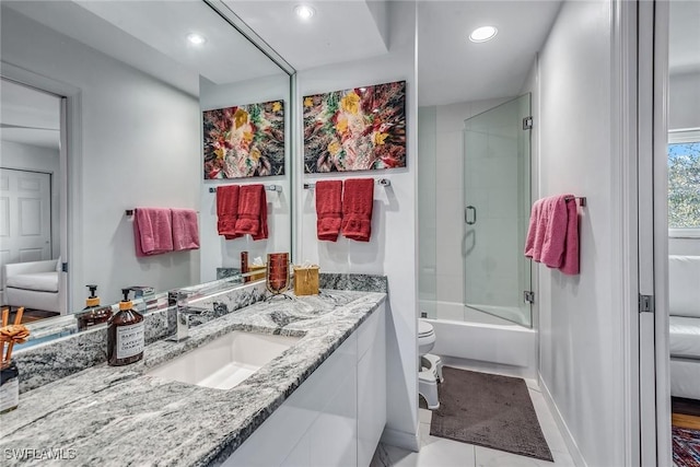 full bathroom featuring enclosed tub / shower combo, tile patterned flooring, vanity, and toilet