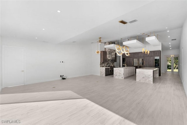 living room with ceiling fan with notable chandelier