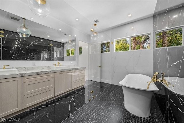 bathroom with vanity, shower with separate bathtub, and tile walls