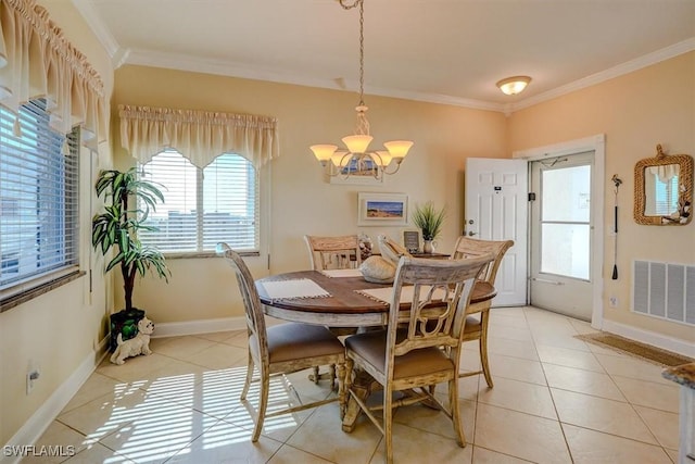 dining area with crown molding, light tile patterned floors, and a chandelier