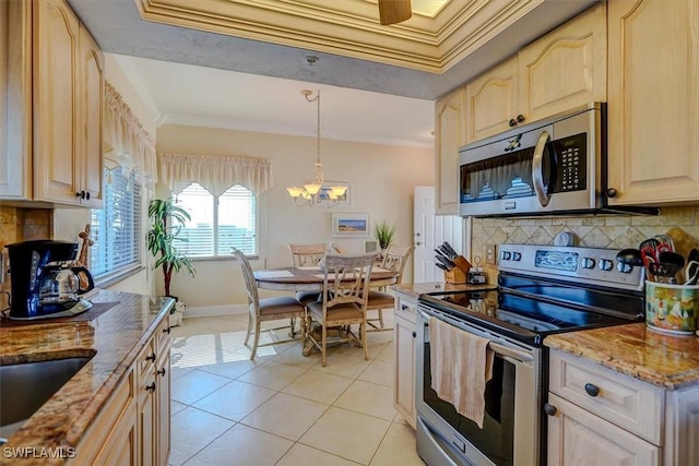 kitchen featuring appliances with stainless steel finishes, light tile patterned floors, ornamental molding, pendant lighting, and decorative backsplash