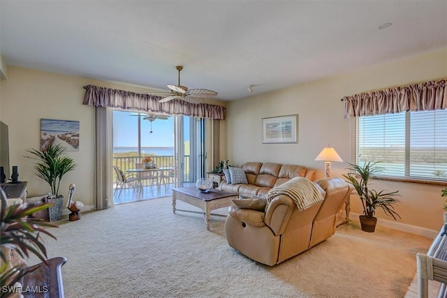 living room featuring ceiling fan and light colored carpet