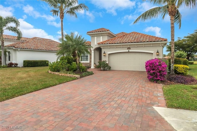 mediterranean / spanish-style house featuring a front lawn and a garage