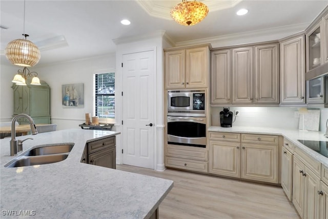 kitchen featuring sink, stainless steel appliances, crown molding, and pendant lighting