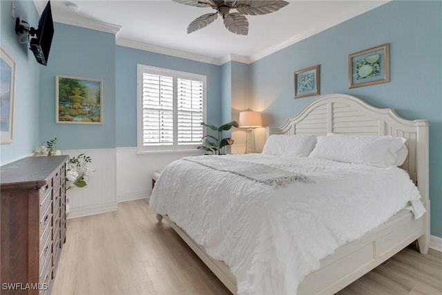 bedroom featuring ornamental molding, ceiling fan, and light wood-type flooring