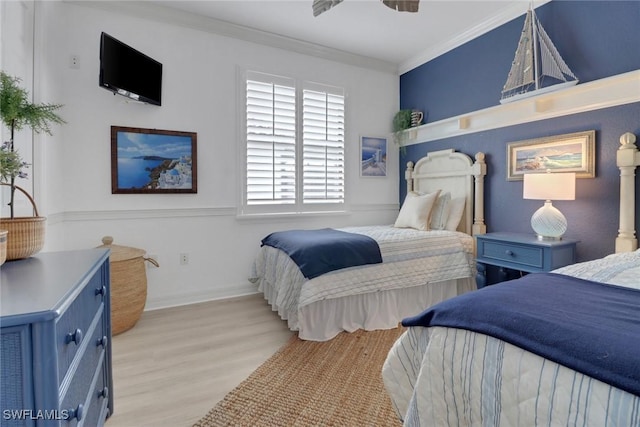 bedroom with ceiling fan, light hardwood / wood-style floors, and crown molding