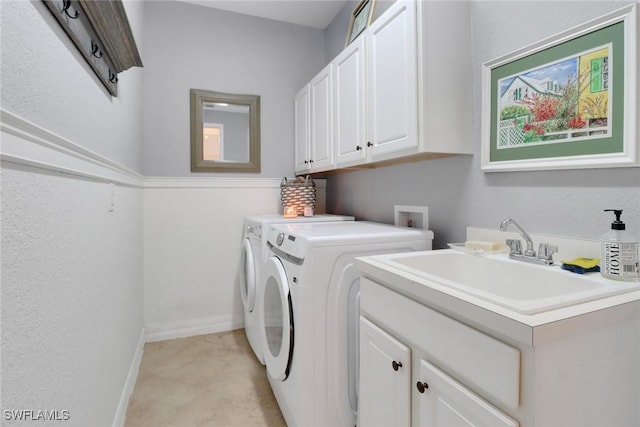 laundry room with separate washer and dryer, cabinets, sink, and light tile patterned floors