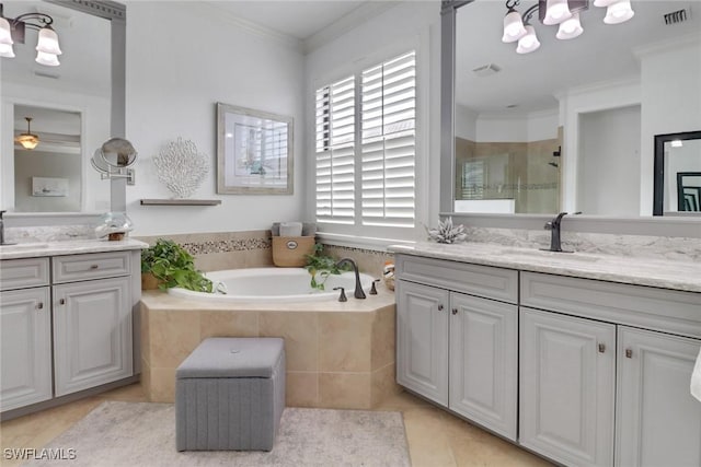 bathroom with ornamental molding, independent shower and bath, vanity, and tile patterned floors