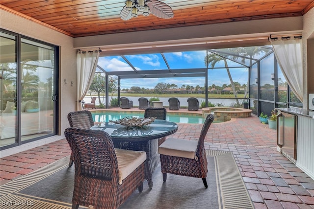 sunroom / solarium with ceiling fan, a water view, and wooden ceiling