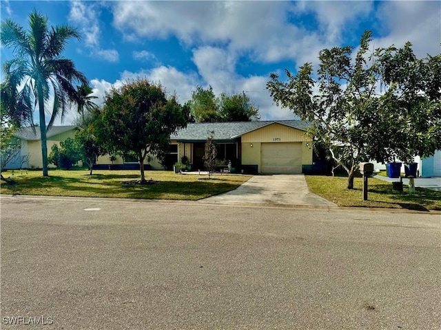 single story home with a front yard and a garage