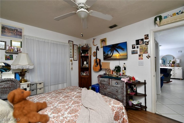 bedroom with ceiling fan and tile patterned flooring