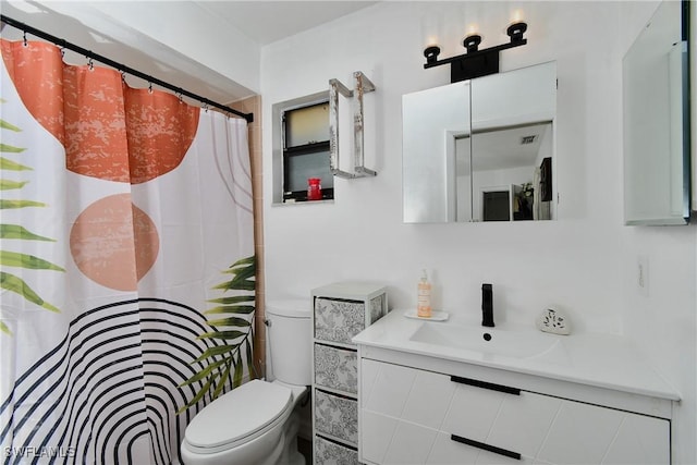 bathroom featuring toilet and vanity