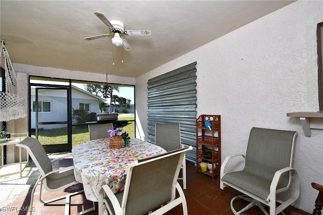 sunroom / solarium featuring ceiling fan and a healthy amount of sunlight