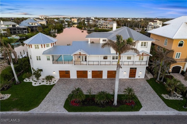 view of front facade with a balcony and a front yard