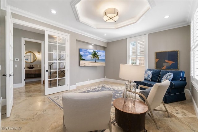 sitting room with a tray ceiling and crown molding