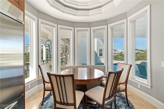 sunroom / solarium featuring plenty of natural light and a tray ceiling