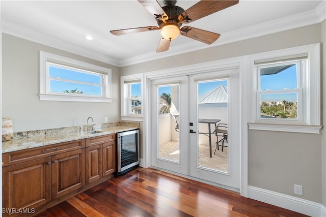 interior space with beverage cooler, french doors, sink, dark hardwood / wood-style floors, and crown molding