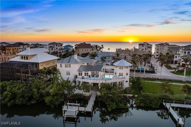 aerial view at dusk with a water view