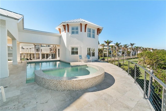 back of house featuring a pool with hot tub