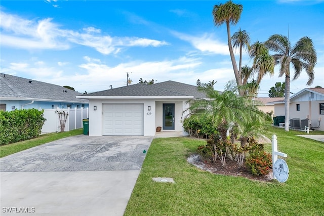 ranch-style house with a garage, central AC, and a front yard