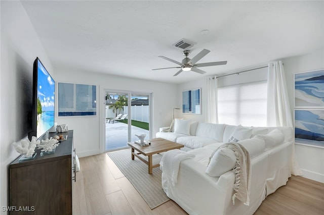 living room featuring light hardwood / wood-style flooring and ceiling fan