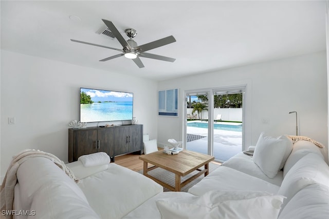 living room featuring ceiling fan and light hardwood / wood-style flooring