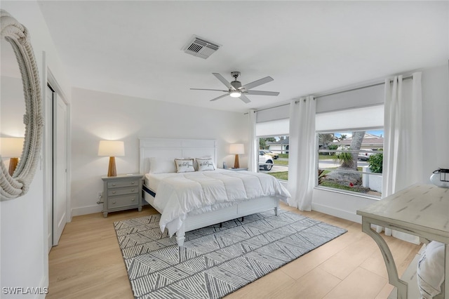 639 98th Ave N, Naples, FL 34108 - bedroom with light wood-style flooring, a ceiling fan, and baseboards