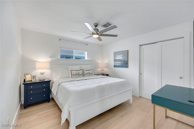 639 98th Ave N, Naples, FL 34108 - bedroom with light wood-style floors, a closet, a ceiling fan, and baseboards