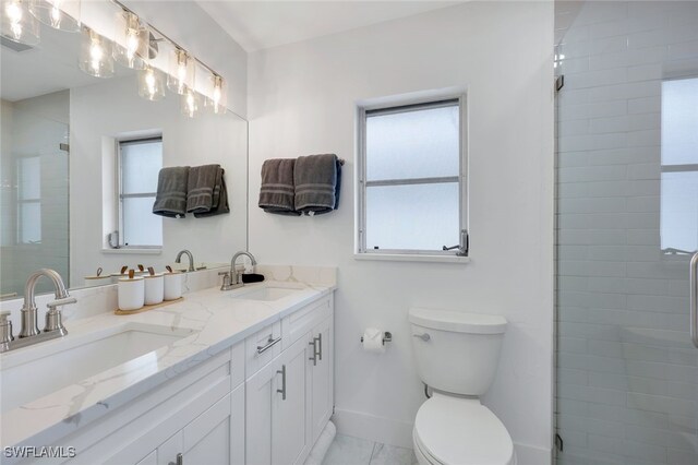 bathroom with toilet, an enclosed shower, and vanity