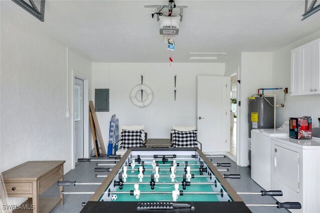 playroom with electric water heater, electric panel, and washing machine and clothes dryer