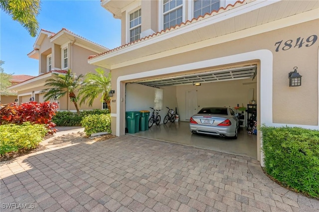 garage featuring decorative driveway