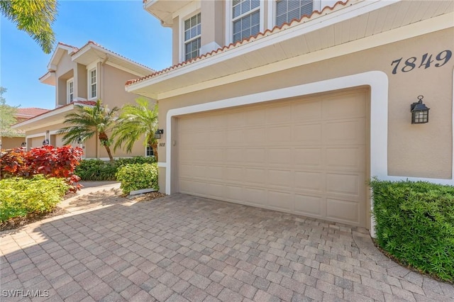 garage featuring decorative driveway