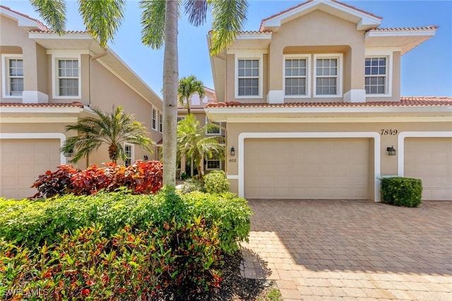 mediterranean / spanish-style home with a garage