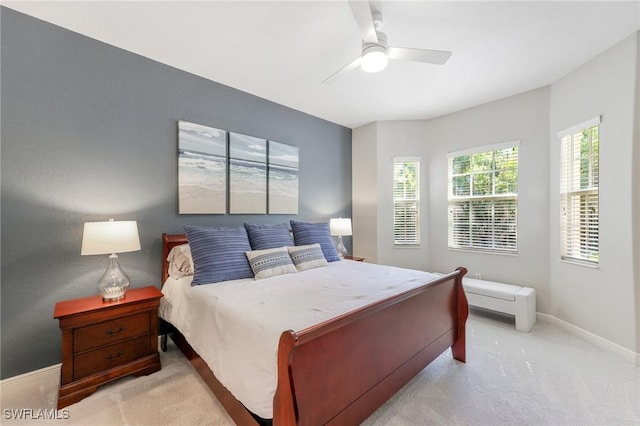 carpeted bedroom with ceiling fan and baseboards