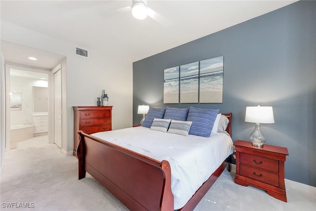 bedroom with connected bathroom, carpet flooring, a ceiling fan, baseboards, and visible vents