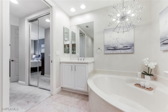 ensuite bathroom with ensuite bathroom, a bath, and vanity