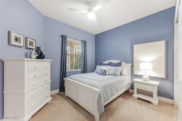 bedroom with ceiling fan, baseboards, and light colored carpet