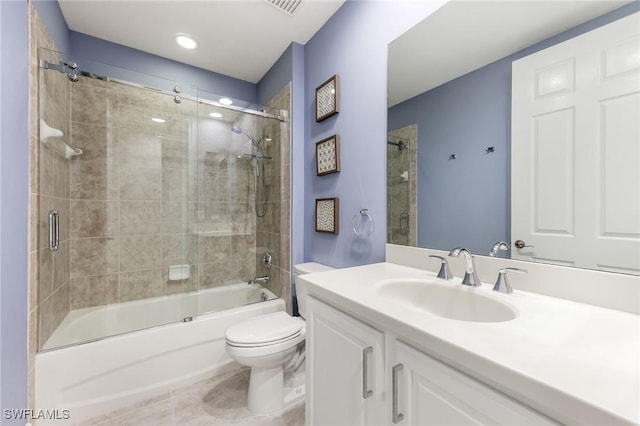 bathroom with toilet, tile patterned floors, bath / shower combo with glass door, and vanity