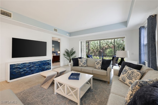 living room featuring visible vents and tile patterned floors