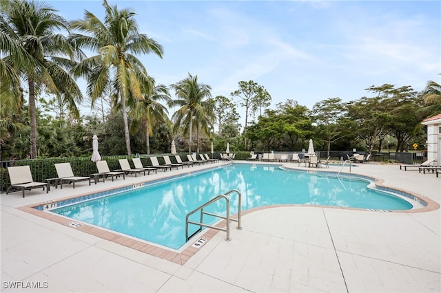 community pool featuring a patio area and fence