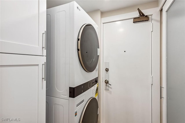 laundry area featuring stacked washer / drying machine