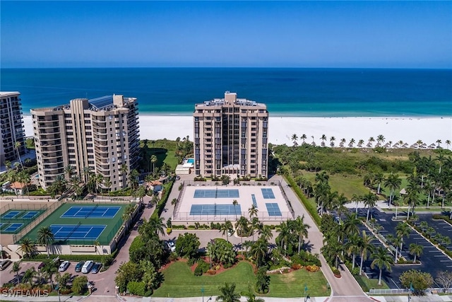 birds eye view of property with a water view and a beach view