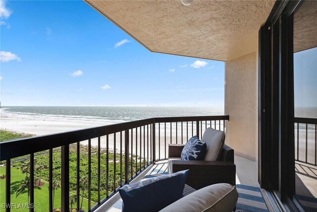 balcony with a beach view and a water view