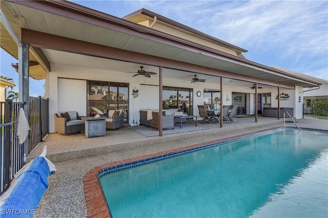 view of pool featuring a patio, ceiling fan, and an outdoor living space