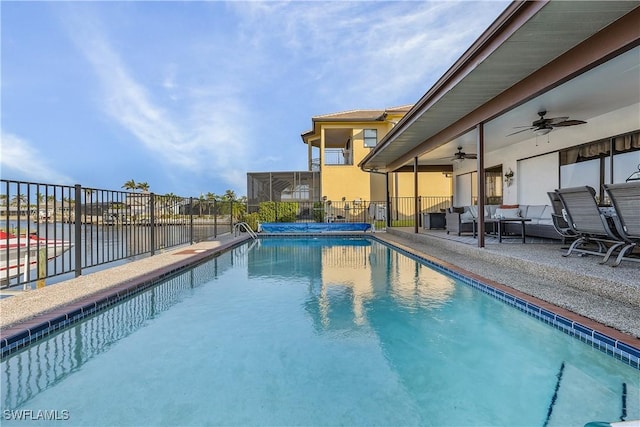 view of pool with ceiling fan and a patio